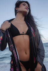 A model wearing the Tahitian Pearl necklace and the earrings with  at beach, with the red Dragon Raising Japanese Long Kimono Robe